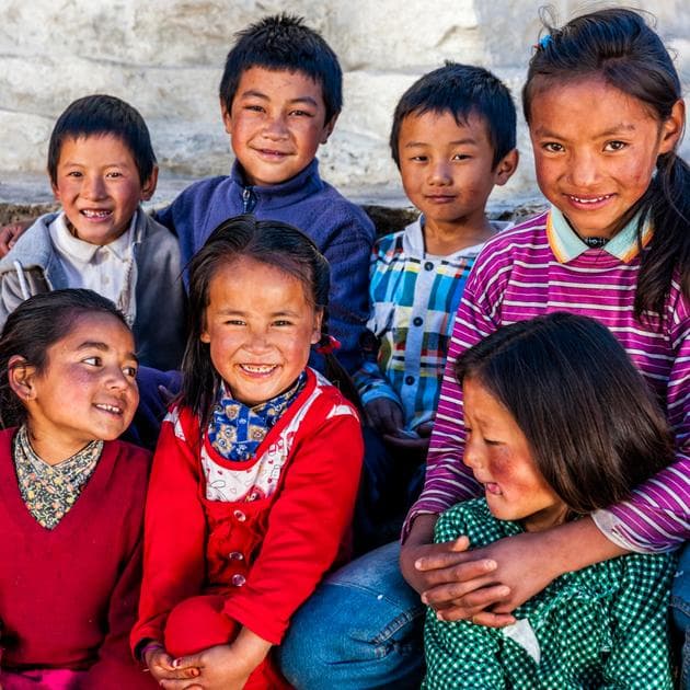 A group of children with bright clothes smiling